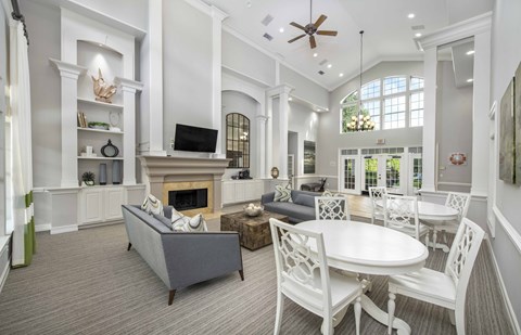 a living room with a table and chairs and a fireplace